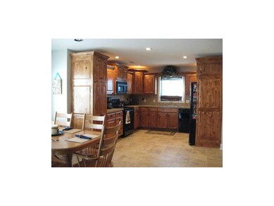 Large country kitchen with knotty alder cabinets, 