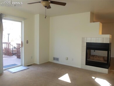 Bright Living Room with Gas Fireplace looking out 