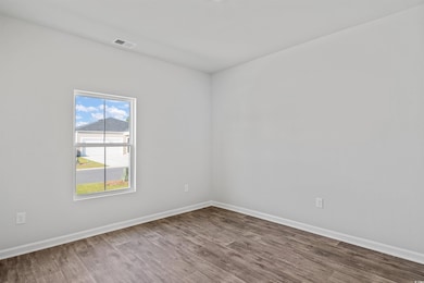 Spare room with wood finished floors and baseboards