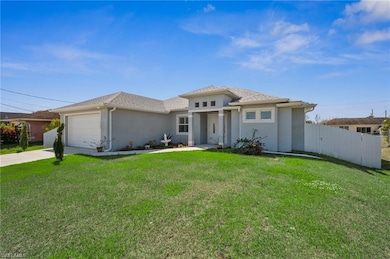 View of front of house with a garage, a front yard