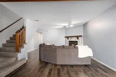 Living room featuring a fireplace, dark hardwood / wood-style flooring, and a textured ceiling