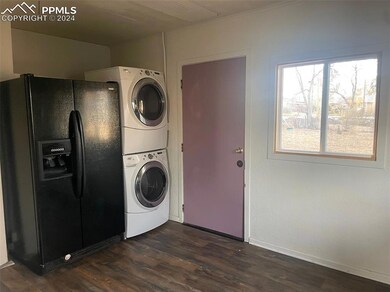 Washroom with dark hardwood / wood-style floors an