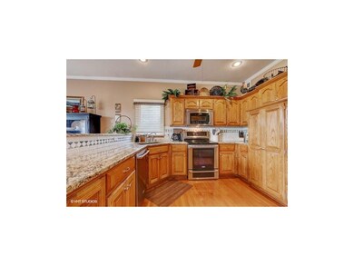 Kitchen features granite countertops, backsplash, 