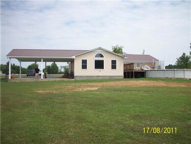 SIDE VIEW OF 2 CAR CARPORT AND ABOVE GROUND POOL