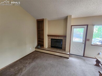 Sitting room with a textured ceiling, carpet floor