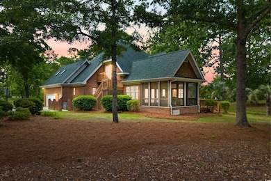 View of front of home featuring a sunroom, brick s