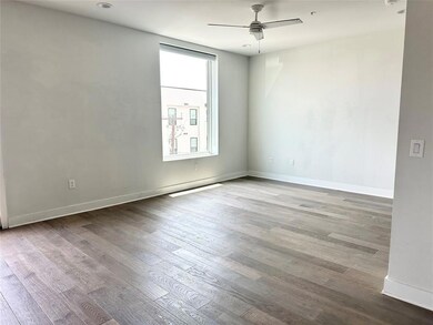 Empty room featuring ceiling fan and wood finishe
