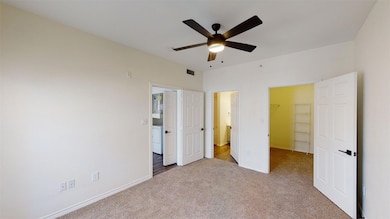 Unfurnished bedroom with a walk in closet, baseboa