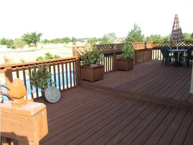 Oversize large deck overlooking pool and pond.