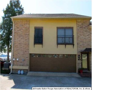 Two car garage. Brick & iron encased windows.