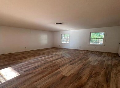Spare room featuring hardwood / wood-style floorin