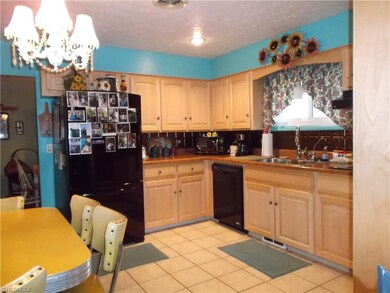 Updated kitchen features beautiful maple cabinets,