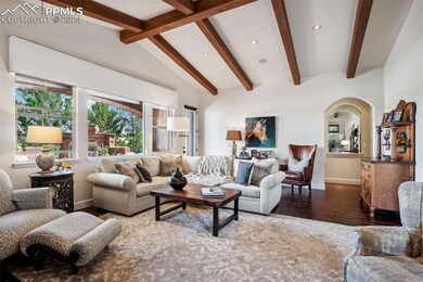 Living room with vaulted ceiling and hardwood / wo