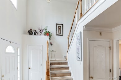Staircase with hardwood / wood-style flooring and