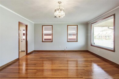 Dining room/ living room with large front window a
