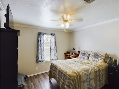 Bedroom featuring wood finished floors, baseboards