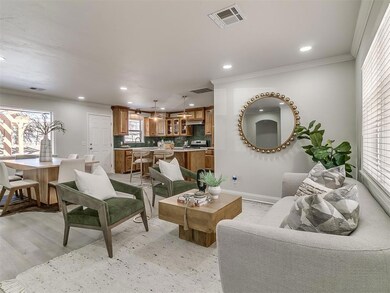 Living room featuring sink, light hardwood / wood-