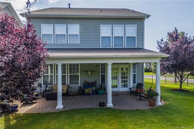 A spacious, brick paver covered patio opens to a l