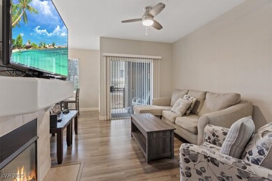 Living area featuring ceiling fan, wood finished f