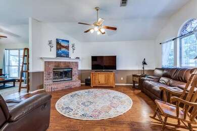Living room with ceiling fan, hardwood / wood-styl
