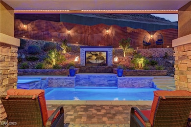Outdoor pool featuring an in-ground hot tub