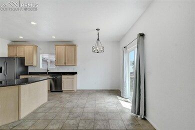 Kitchen with light brown cabinets, dishwashing machine, stainless steel fridge, healthy amount of natural light, and recessed lighting