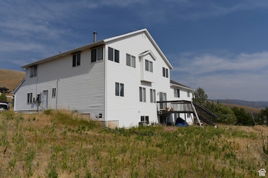 Rear view of property with a wooden deck and stairs