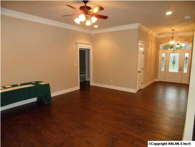 Family room has 10 foot ceilings, natural gas fireplace, wood flooring, ceiling fan, recessed lighting.