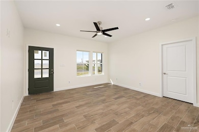 Unfurnished room with recessed lighting, wood tiled floors, and ceiling fan