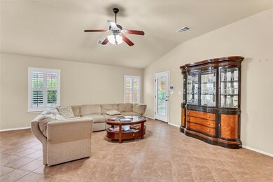 Tiled living area featuring lofted ceiling and ce