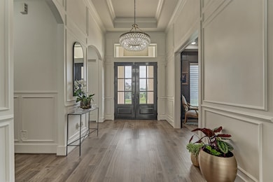 Picture frame molding throughout the hall and multiple areas of the home, showcasing exquisite craftsmanship.