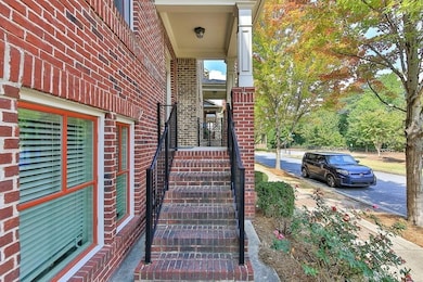 Doorway to property featuring brick siding