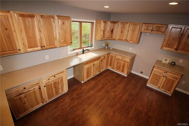 Brand new hickory cabinets, flooring and solid sur