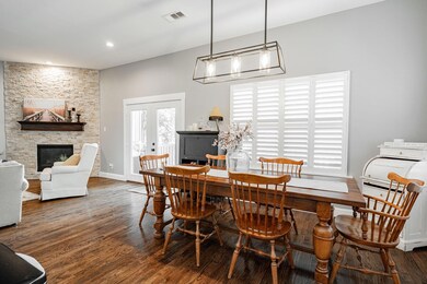 Dining room with french doors, a stone fireplace, 