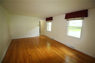 The spacious living room features a neutral decor 