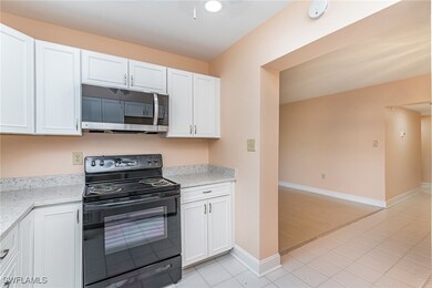 Kitchen with black electric range, stainless steel