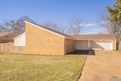 Exterior space with a garage and a yard