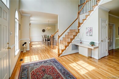 2-Story Foyer with glowing wood floors, open to Di