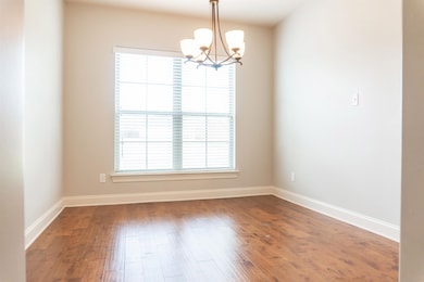 Unfurnished room with baseboards, wood finished fl