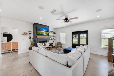 Living room featuring ceiling fan, a fireplace