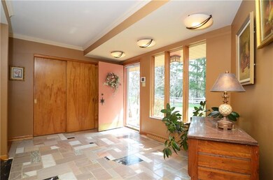 The entry offers unique marble tile and crown mold