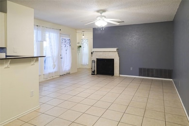 Unfurnished living room with a ceiling fan, a tex