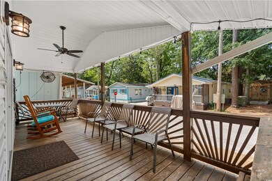 Wooden deck featuring ceiling fan and a residentia