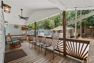 Wooden deck featuring ceiling fan and a residential view