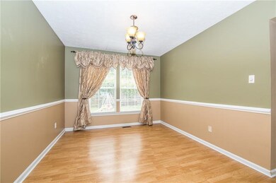Formal dining room with chair rail, lots of natura