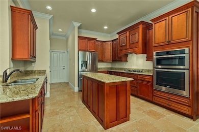 Kitchen featuring stainless steel appliances, a si