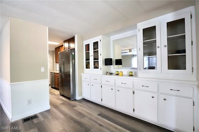 Kitchen with stainless steel refrigerator with ice