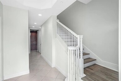 Stairway featuring private elevator, recessed ligh
