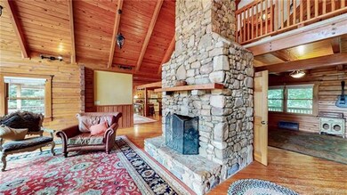 Dramatic stone fireplace with gas logs on main flo