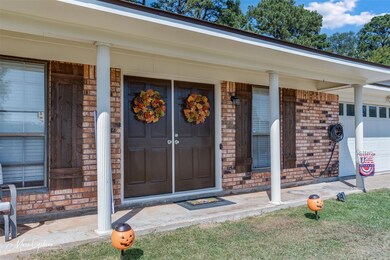Entrance to property featuring covered porch and a